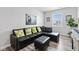 Cozy living room features a black sectional sofa, patterned pillows, and modern decor at 5848 Sheffield Ln, Whitestown, IN 46075