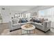 Spacious living room with gray sofa, a view of the kitchen and lots of natural light at 5848 Sheffield Ln, Whitestown, IN 46075