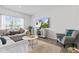 Bright living room featuring a gray sofa set and large TV for comfortable entertaining at 5848 Sheffield Ln, Whitestown, IN 46075