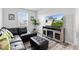 Stylish living room with a comfortable sectional sofa, a media center with a large TV, and modern decor at 5848 Sheffield Ln, Whitestown, IN 46075