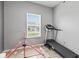 A simple spare room featuring a treadmill and other exercise equipment at 5848 Sheffield Ln, Whitestown, IN 46075