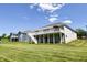 Landscaped backyard featuring a multi-level deck, green lawn, and adjacent properties at 6110 Pelican Ln, Columbus, IN 47201