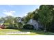 Two-story home with neutral siding, mature trees, and a community gathering room at 6110 Pelican Ln, Columbus, IN 47201