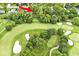 Scenic aerial view of a home nestled in a wooded area near the lush green fairways of a golf course at 6115 E 65Th Pl, Indianapolis, IN 46220