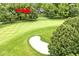 An aerial view of a golf course community with a home and sand trap in view at 6115 E 65Th Pl, Indianapolis, IN 46220