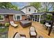 Backyard deck with hot tub, patio furniture, and screened-in porch, perfect for outdoor relaxation and entertaining at 6115 E 65Th Pl, Indianapolis, IN 46220