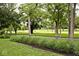 Beautiful backyard with mature trees and a golf course view, perfect for relaxing and enjoying nature at 6115 E 65Th Pl, Indianapolis, IN 46220