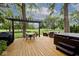 Outdoor deck with hot tub, dining table, and lounge chairs, all shaded by a pergola at 6115 E 65Th Pl, Indianapolis, IN 46220