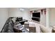 Basement rec room with a large leather sectional, wall-mounted TV, and sports-themed decor at 6115 E 65Th Pl, Indianapolis, IN 46220