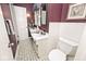 Charming bathroom with plum colored walls, vanity, and white tiled floor at 6115 E 65Th Pl, Indianapolis, IN 46220