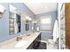Updated bathroom with a double vanity, stylish fixtures, and modern lighting at 6115 E 65Th Pl, Indianapolis, IN 46220