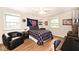 Relaxing bedroom with hardwood floors, ceiling fan, and lots of natural light at 6115 E 65Th Pl, Indianapolis, IN 46220