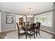 Dining room with a bay window, chandelier, and a view into another room at 6115 E 65Th Pl, Indianapolis, IN 46220