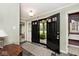 Welcoming entryway with black slate tile, sidelight windows, and view to yard at 6115 E 65Th Pl, Indianapolis, IN 46220