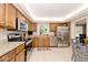 Well-lit kitchen with stainless steel appliances, granite countertops, and ample cabinet space at 6115 E 65Th Pl, Indianapolis, IN 46220