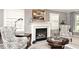 Elegant living room featuring a fireplace, plush seating, and large windows that flood the space with natural light at 6115 E 65Th Pl, Indianapolis, IN 46220
