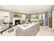 Elegant living room featuring a fireplace, plush seating, and large windows that flood the space with natural light at 6115 E 65Th Pl, Indianapolis, IN 46220