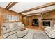 Inviting living room features a fireplace, wood paneling, and a neutral color palette at 6115 E 65Th Pl, Indianapolis, IN 46220