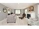 Elegant living room featuring a fireplace, plush seating, and large windows that flood the space with natural light at 6115 E 65Th Pl, Indianapolis, IN 46220