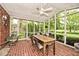 This screened-in porch features a brick floor, white wood paneled ceiling, and outdoor views at 6115 E 65Th Pl, Indianapolis, IN 46220