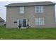 View of the backyard featuring a vinyl siding, sliding door, a grill, and two chairs at 615 Albermarle Dr, Pittsboro, IN 46167