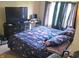 Bedroom with a floral comforter, window with dark curtains, and a desk at 615 Albermarle Dr, Pittsboro, IN 46167