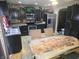 View of a kitchen featuring dark wood cabinetry and stainless steel appliances, plus a table setting for two at 615 Albermarle Dr, Pittsboro, IN 46167