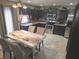 View of kitchen with dark wood cabinets, stainless steel appliances, tile backsplash, and a table with seating for four at 615 Albermarle Dr, Pittsboro, IN 46167