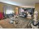 Open concept living room featuring an ornate sofa, table setting, and view of the kitchen at 615 Albermarle Dr, Pittsboro, IN 46167