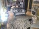 View of a living room featuring a love seat, mirrored fireplace, and access to the kitchen at 615 Albermarle Dr, Pittsboro, IN 46167