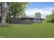 A large backyard features mature trees and green grass at 625 E 106Th St, Carmel, IN 46280