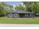 Charming single-story home with a well-manicured lawn and gray siding at 625 E 106Th St, Carmel, IN 46280