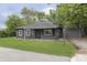 Quaint one-story home with a tidy lawn and gray exterior at 625 E 106Th St, Carmel, IN 46280