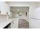 Bright kitchen boasts white cabinets and modern appliances, open to the living area at 625 E 106Th St, Carmel, IN 46280