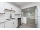 Bright kitchen featuring white cabinets, stainless steel dishwasher, and modern sink at 625 E 106Th St, Carmel, IN 46280