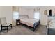 Bedroom with neutral walls and carpet features a black metal frame bed and soft natural light at 6450 N State Road 75, North Salem, IN 46165