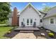 Charming home featuring a brick chimney, a cozy deck with seating, and a well-maintained yard at 6450 N State Road 75, North Salem, IN 46165
