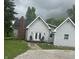 Charming single-story house featuring a brick chimney and a cozy front porch with seating at 6450 N State Road 75, North Salem, IN 46165