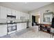 Bright kitchen boasts white cabinets, stainless steel appliances, and an adjacent living area at 6450 N State Road 75, North Salem, IN 46165