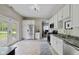 The kitchen features stainless steel appliances, white cabinets, and access to a back door at 6450 N State Road 75, North Salem, IN 46165