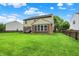 Large, well-maintained backyard with a wooden deck, brick accents, and a charming picket fence at 7312 Drum Castle Ct, Indianapolis, IN 46259