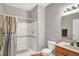 This bathroom features a toilet, sink, and shower with a shower curtain and grab bars at 7312 Drum Castle Ct, Indianapolis, IN 46259