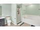 Bright bathroom features a tub with jets, glass-enclosed shower, and tiled floors at 7312 Drum Castle Ct, Indianapolis, IN 46259