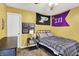 This bedroom features sports memorabilia, a ceiling fan, a bed, and a nightstand with a lamp at 7312 Drum Castle Ct, Indianapolis, IN 46259