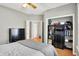 This bedroom features a ceiling fan, hardwood floors, and a closet with shelving at 7312 Drum Castle Ct, Indianapolis, IN 46259