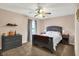 This bedroom features a ceiling fan, dresser, two night stands, a bed, and a window at 7312 Drum Castle Ct, Indianapolis, IN 46259