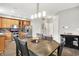 Inviting dining area with modern lighting and a view into the updated kitchen at 7312 Drum Castle Ct, Indianapolis, IN 46259