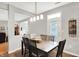 Cozy dining area with modern lighting and a view into the living area at 7312 Drum Castle Ct, Indianapolis, IN 46259
