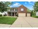 Charming two-story home with brick and siding, a well-manicured lawn, and a three-car garage at 7312 Drum Castle Ct, Indianapolis, IN 46259