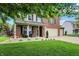 Inviting front yard with lush green lawn, landscaping, a cozy porch, and a brick and siding exterior at 7312 Drum Castle Ct, Indianapolis, IN 46259